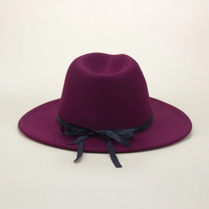 Detailed view of dark purple wool fedora hat with elegant black bow and pearl accent