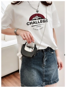 Mini black glossy crossbody bag with silver metal handle and delicate chain strap details