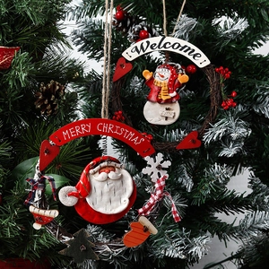 Festive Christmas wreath featuring Santa and Snowman figures on natural vine rings