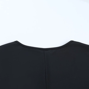 Detail of the back neckline on a black elegant dress with ruffle mesh stitching