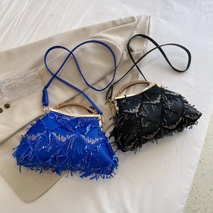Detail of blue and black evening bags with sequins embroidery and tassel fringes