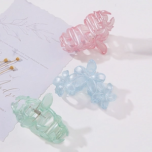 Three-piece floral hair claw clips in pastel pink, light blue, and mint green colors