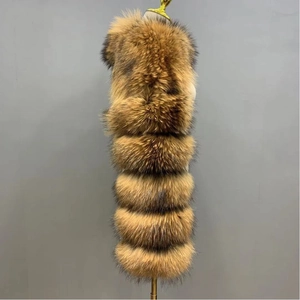 Detail of faux fox fur vest showing layered horizontal stitching and natural brown texture