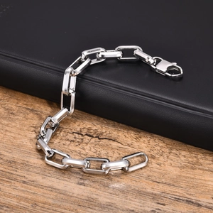 Detailed close-up of a silver stainless steel rectangular link bracelet with lobster clasp