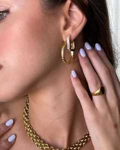 Detailed close-up of gold chunky chain necklace and matching jewelry set with zircons