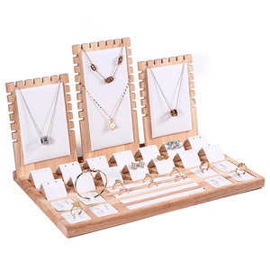 Wooden jewelry display set with white leather pads for necklaces and rings