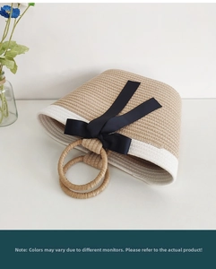 Detail of hand-woven tote bag featuring a round handle and elegant black satin bow