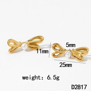 Detail of gold bow earrings with white pearl, dimensions 25mm width by 11mm height