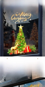 Detail of Christmas tree and golden reindeer static stickers on a festive glass window