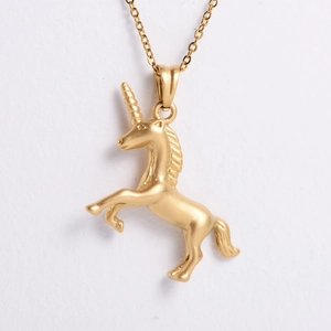 Macro detail of a golden sandblasted unicorn pendant necklace with a matte finish