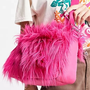 Detailed view of fluffy rose pink faux fur shoulder bag with plush long hair texture