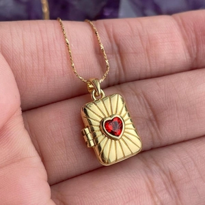 Vintage gold locket necklace with square pendant and central red heart zircon gem