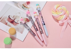 Close-up of glitter quicksand pens with cute chicken and swan cartoon toppers