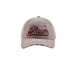 Close-up of red Classic embroidery and distressed details on vintage khaki cotton baseball cap