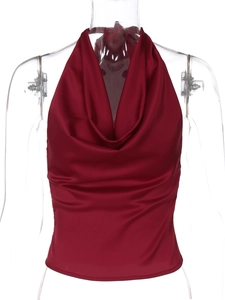 Detailed close-up of glossy burgundy satin halter top with elegant draped neckline detail