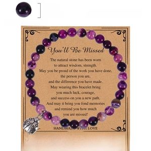 Purple striped agate bead bracelet with silver ladybug pendant on a gift card
