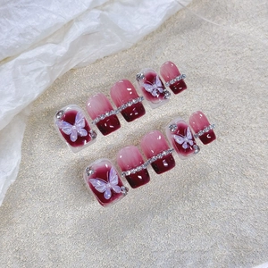 Elegant burgundy gradient press-on nails featuring 3D butterflies and sparkling rhinestones.