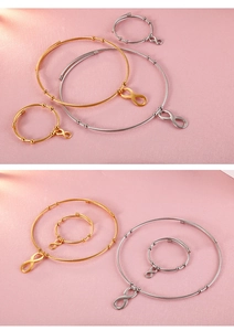 Detailed view of infinity charm bracelets and rings in gold and silver finishes