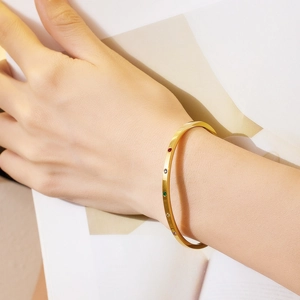 Detailed close-up of 18k gold plated stainless steel bangle set with colorful zircons