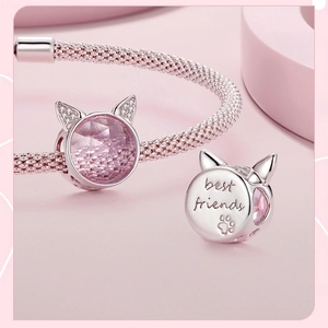 Detail of pink mesh bracelet with cat charm and engraved best friends pendant