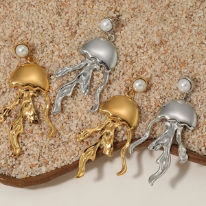 Ocean series jellyfish drop earrings with pearls in gold and silver finish on sand