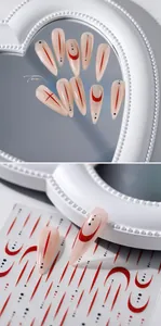 Detail of 5D pink stiletto fake nails with red line art and matching nail stickers