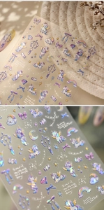 Detailed macro view of laser holographic unicorn and rainbow nail art stickers set