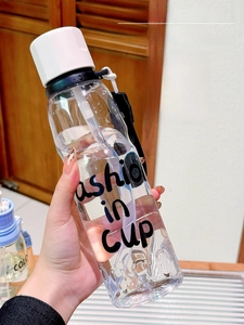 Portable cartoon straw cup with Fashion in Cup text and black carry handle strap