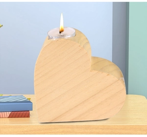 Macro shot of heart-shaped pine wood candle holder with natural grain and burning tealight