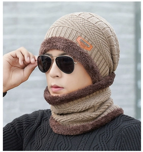 Detail of khaki cable knit beanie and neck warmer with plush lining on a male model