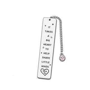 Detail of silver stainless steel bookmark with pink rhinestone and heart shape engraving