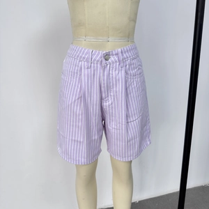 Detail of purple and white striped high-waisted denim shorts with metal button closure