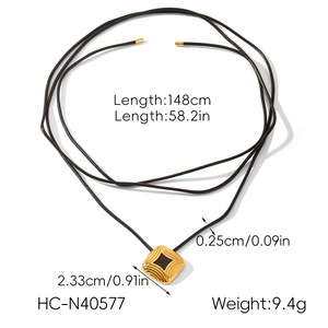 Detail view of square gold pendant with black inlay and cord chain specifications