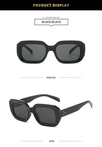 Detail view of retro square black sunglasses with silver rivet accents and grey lenses