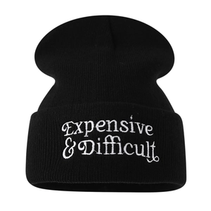 Black knit beanie featuring Expensive & Difficult white letter embroidery in a street style