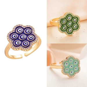 Detail view of heart-shaped evil eye enamel rings with sparkling zircon accents in three colors