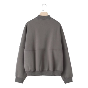 Detail view of the back of a dark grey zip-up bomber jacket with ribbed cuffs and hem