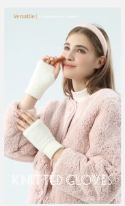 Close-up of white plush knitted fingerless gloves worn with a cozy winter outfit
