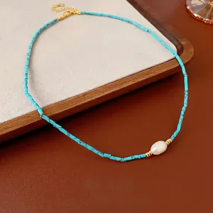 Blue turquoise tube necklace with white baroque pearl on dark brown leather base