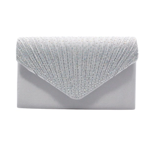 Macro view showing silver satin fabric and sparkling rhinestones on an evening clutch bag