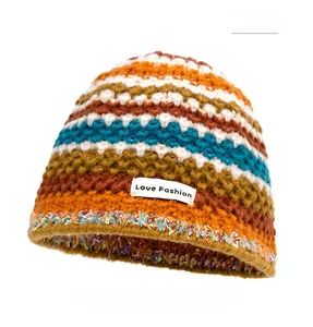 Detail of colorful striped knitted beanie with Love Fashion label and fringe edges
