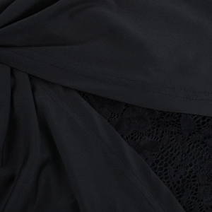 Detailed macro shot of black lace pattern and knit fabric stitching on a dress