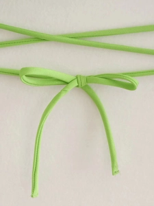 Detail of neon green ribbed fabric featuring an adjustable tie-up bow design