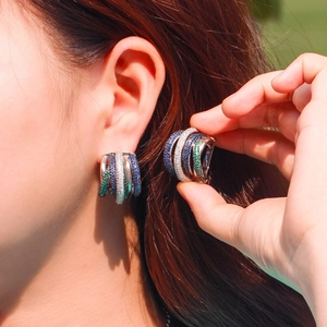 Elegant multi-layer hoop earrings with green blue and white micro-set zircons on model