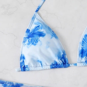 Detailed macro shot of blue and white floral bikini top with premium stitching and texture