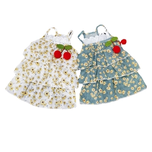 Detail of floral pet dresses with lace trim and decorative cherry accents in two colors