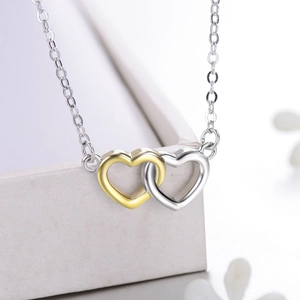 Elegant S925 sterling silver necklace featuring interlocking gold and silver hearts