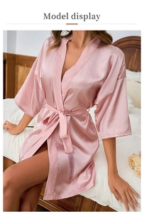 Pink satin robe detail featuring a stylish belted waist with elegant fringe tassels