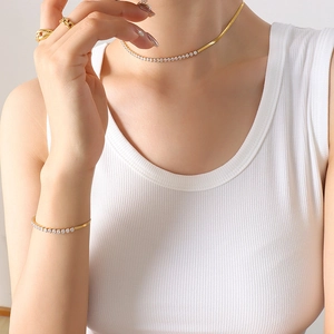 Elegant gold-plated jewelry set with zircon crystals featuring necklace and bracelet