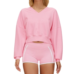 Pink two-piece athletic set featuring a hooded sweatshirt and matching side-stripe shorts